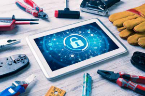 stock photo of tools around an ipad with a cyber lock symbol on the screen